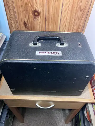 Relive the magic of classic films with this vintage Movie-Mite 60mm film projector, a piece of cinem...