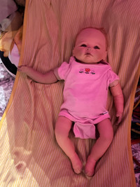 Baby doll with baby clothes (missing a little bit of the hand 