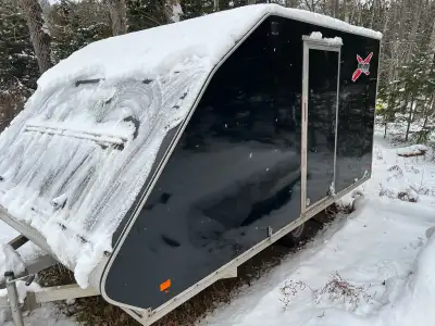 Well cared for trailer, inside all finished, with spare tire, sled tie downs, rubber added to ramp a...