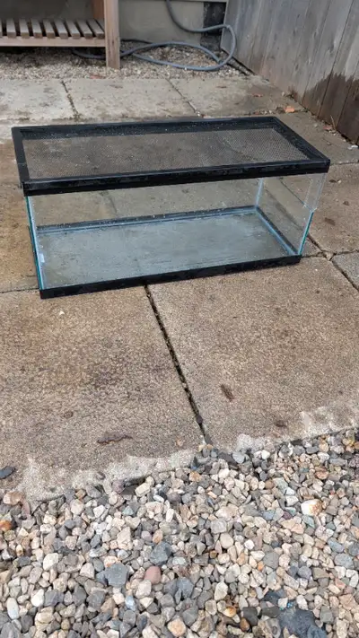 Used turtle tank and filter. Holds water. Used for juvenile turtle. Opening on the side of the glass...