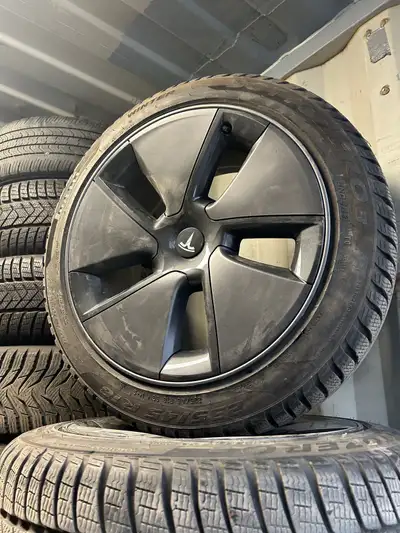 18” OEM Tesla Model 3 rims with 235-45-18 pirelli sottozero winter tires. In excellent condition. Ti...