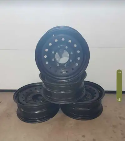 Four almost new 16 inch steel 8 hole rims with valve stems installed. Includes 4 wheel covers.
