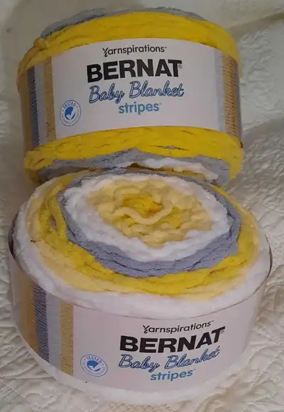 Bernat Baby Blanket stripes. New. 2 yarn cakes for $20. Colour is sunshine.