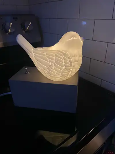 Add a whimsical touch to your home with this gently used bird lamp. It casts a warm, ambient glow, p...