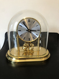 Vintage quartz Ergo mantle clock with glass dome.9” tall.
