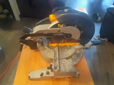 This is a used DeWalt miter saw, perfect for any job site or home renovation project. It's in fair c...