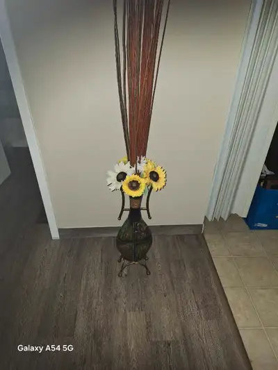 Tin vaze with flowers..$15.oo cash.. * Height: Approximately 4 feet * Style: Decorative * Accents: F...