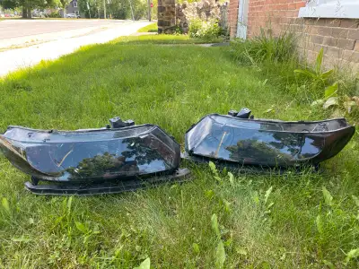 These are a pair of smoked headlights for a Honda 2006-2011 coupe. They are used and show some signs...
