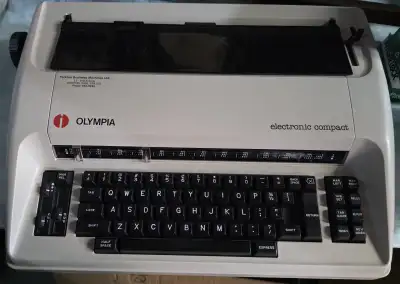 Vintage Olympia Electronic Compact Electric Portable Typewriter. Comes with power cord.