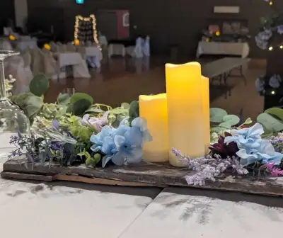 Rustic wedding decorations. A combination of real barn board and artificial flowers for centrepieces...
