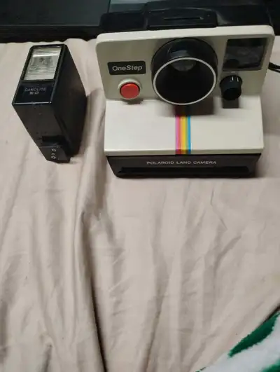 This is a used Polaroid OneStep instant camera, a classic piece of photography equipment. Known for...