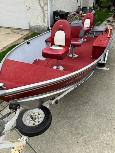 16 foot Lund aluminum fishing boat with a flat floor, 3 pedestal seats and a 25 HP Johnston tiller m...