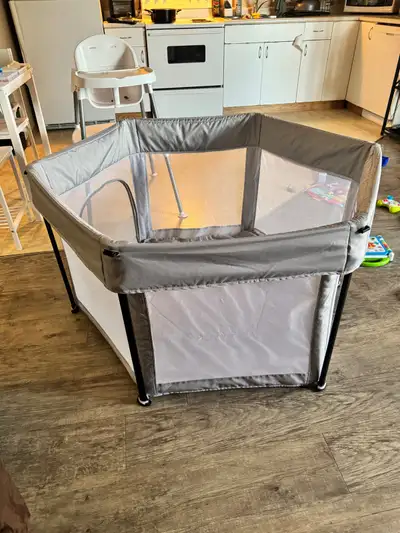 Portable playpen in good condition, minor tear in the removable floor material at the bottom (shown...