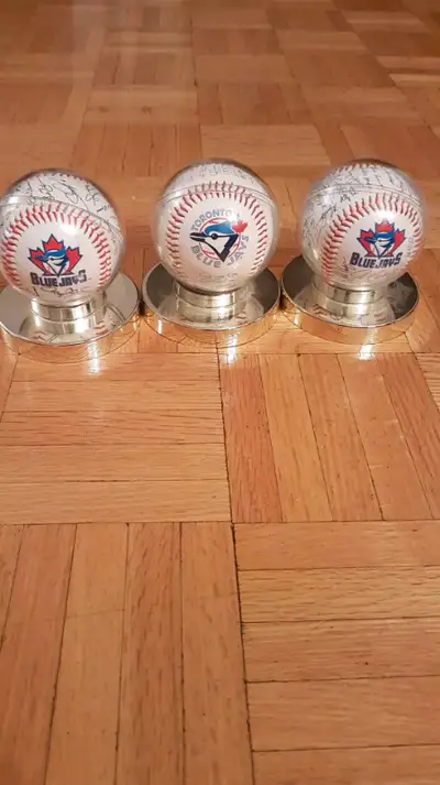 Three Toronto Blue Jays Honda team autographed baseballs on stand.I am not a fan of the baseball gam...