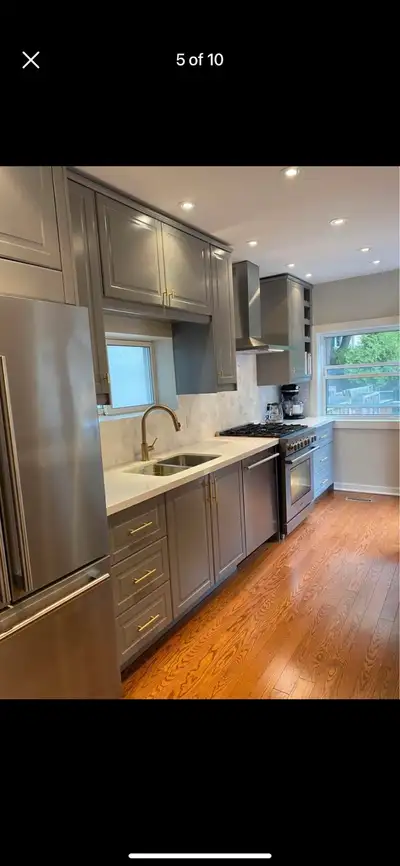 These used kitchen cabinets offer a modern look with their sleek grey finish and gold hardware and Q...