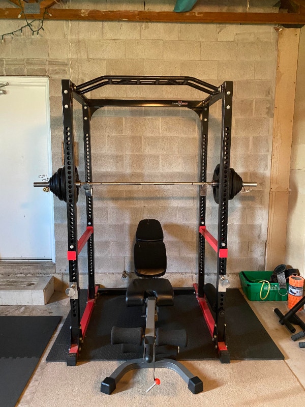 Squat Rack + Power Barbell + Bench + 245lbs Black Metal Plates