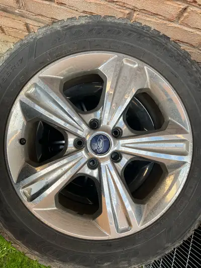 4 winter tires on wheel. 65 to 70% tread left. Wheel covers with ford logo. The tire size is 235/55R...