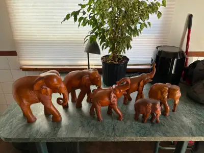 Offering for sale a set of 6 vintage solid teak wood elephants. The tallest Elephant is 13.5" tall....