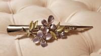 Beautiful silver hair clip with floral design and rhinestones