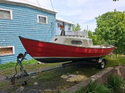 Famous Drascombe sailboat on a trailer with 6 hp Suzuki outboard