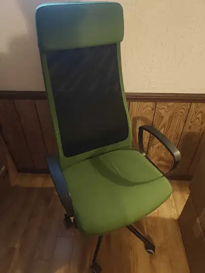 This is a green Ikea Markus office chair featuring a high back and ergonomic design, ideal for long...