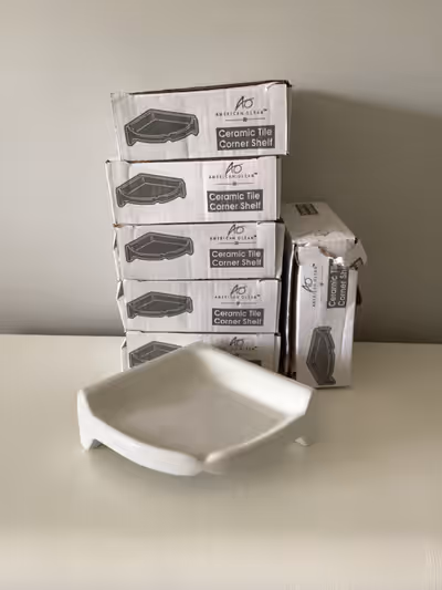 Ceramic corner shelf for shower or bathtub.