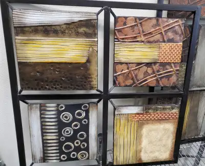 Three pieces of wall art constructed of metal. Two have 4 panels and one has 6 panels