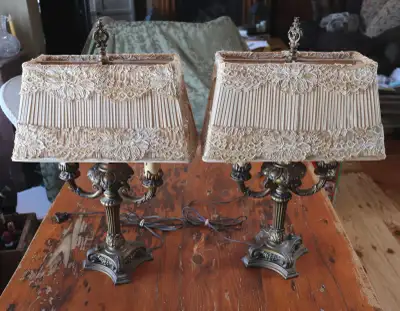Pair of beautiful old Victorian style lamps. The lamps have their original shades with lace accents....