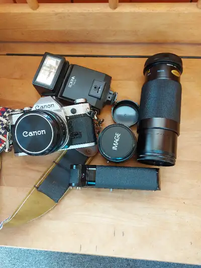 A rare find! CANON AE 1, 28mm, 50mm, 100-300 Zoom, power winder, and Flash. Selling as Package. Exce...