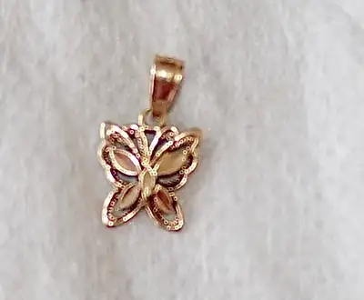 A beautiful 10K solid gold butterfly charm for a pendant. Good as new. A great addition to your chai...