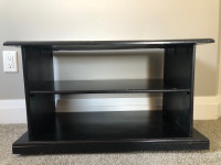 Black wood tv stand/ shelving unit  w/ castors