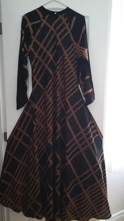 Gorgeous silky long evening dress, never worn, flared design. Should fit medium to large person. Was...