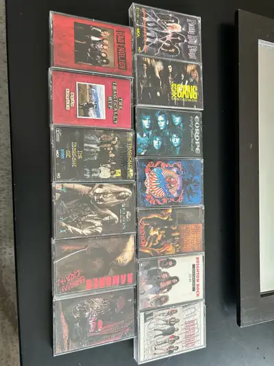 Here's a collection of used 80's rock cassette tapes, perfect for adding some retro vibes to your co...
