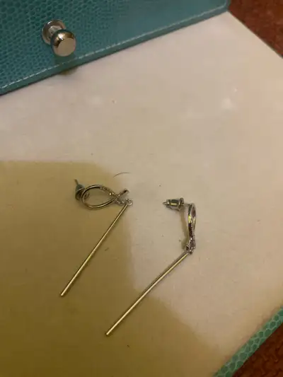 These are used, but fashionable, earrings with a silver finish and linear drop design, perfect for a...