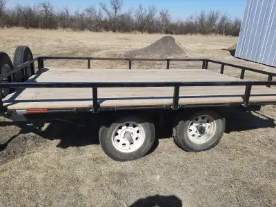 Well made home crafted tandem axle utility trailer. Beveled edge 2x4 bed planks. Steel railing. squa...