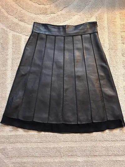 Check out this stylish Danier black leather skirt, perfect for adding a touch of edgy sophistication...