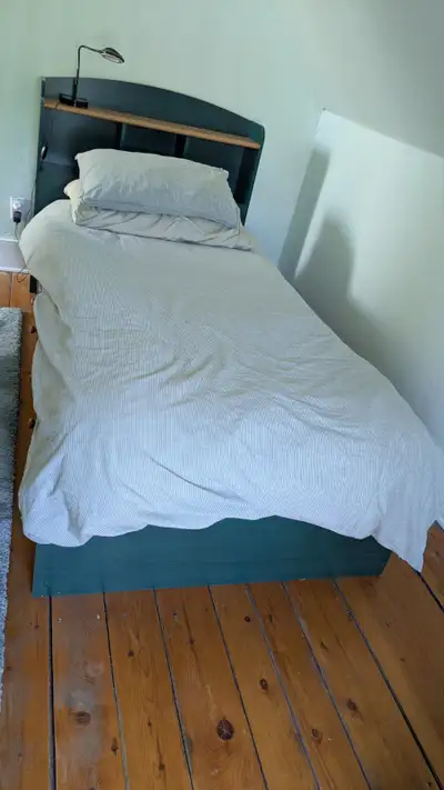 Twin bed with headboard and three drawers., View more