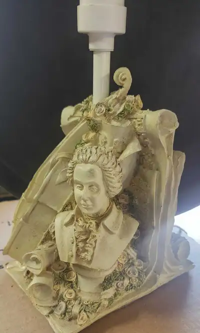 Add a touch of classical elegance to your space with this unique Mozart-themed table lamp! The lamp...