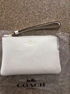 Both brand new, never used. Wristlet model F58032 in Chalk $65. Passport holder model CF887 in Light...