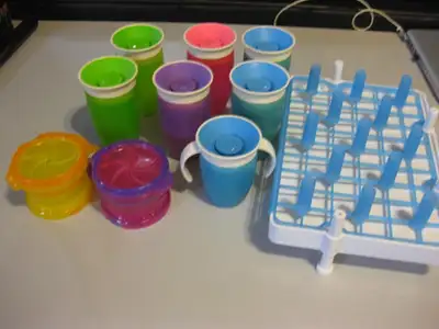 7 Munchkin sippy cups, drying rack and snack containers Ten, View more