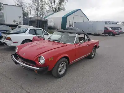 Check out this classic, used red Fiat 124 Spider, a real head-turner that's ready for some top-down...
