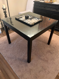 Wooden black dining table with glass top bevelled edge