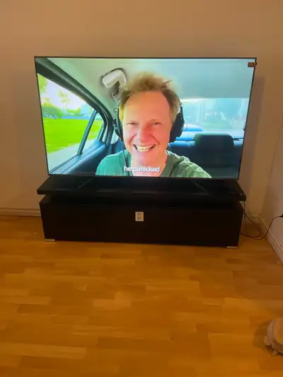 Selling a used 65 inch TCL QLED Smart TV with a sleek TV stand, perfect for your entertainment needs...