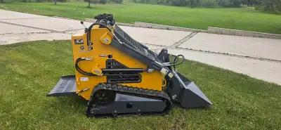 Tracked Mini Skid steer, with bucket, clamshell bucket, pallet forks and angle blade for plowing. Br...