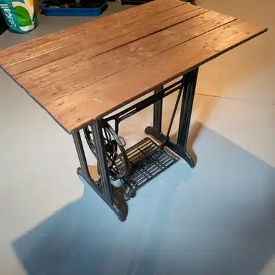 Repurposed antique Singer treadle sewing machine table. Original cast-iron Singer base with the trea...