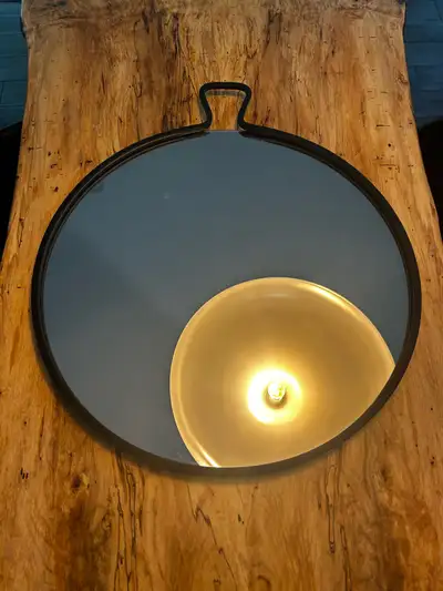 Elevate your space with this stylish round metal frame mirror, perfect for adding a touch of modern...