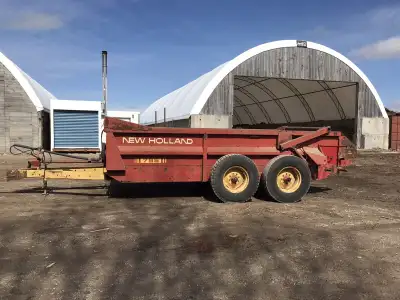 Manure spreader good for firewood or trailer. Tandem axle with good poly floor & hydraulic tailgate....