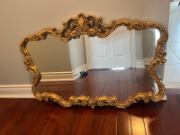Beautiful mirror with ornate gold frame 
