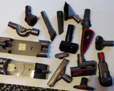 Assorted vacuum cleaner attachments, including Dyson.