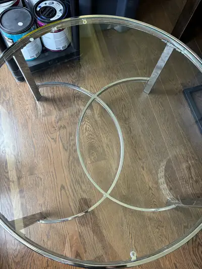 Add a touch of elegance to your living space with this stylish glass coffee table, featuring a sleek...